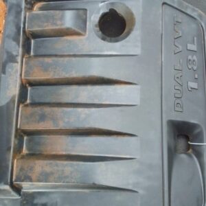 Used engine cover for Jeep Compass shown from the top angle with visible mounting points and surface details.U