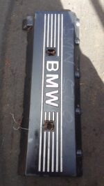 Top view of a used engine cover for BMW E39, showing detailed surface and mounting points.Top view of a used e