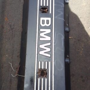 Top view of a used engine cover for BMW E39, showing detailed surface and mounting points.Top view of a used e