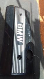 Front angle view of a used BMW E46 engine cover showing surface details and mounting points.Front angle view o