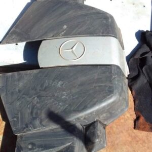 Top-down view of a used black engine cover designed for Mercedes W203, showing mounting points and surface det