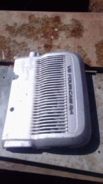 Front angle of a used 2.4L engine cover for a 1996 Toyota Camry, showing minor wear and mounting points.Front