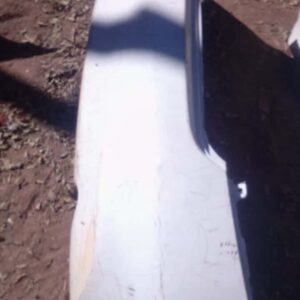 Rear view of a used Nissan Almera rear bumper showing mounting points and slight wear.Rear view of a used Niss