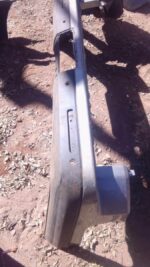 Used rear bumper for Land Rover Discovery shown from rear angle with mounting points visible.Used rear bumper