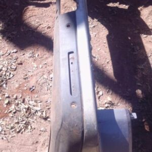 Used rear bumper for Land Rover Discovery shown from rear angle with mounting points visible.Used rear bumper