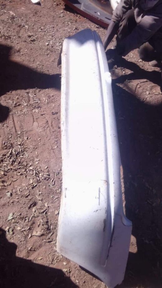 2001 Opel Corsa Lite Rear Bumper - Used Used rear bumper for Opel Corsa Lite shown from an angled front view with mounting points visible.Used rear bu