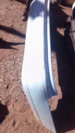 Rear view of a used Toyota Camry rear bumper showing mounting points and surface condition.Rear view of a used
