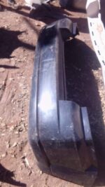 Used rear bumper for Dodge Caliber shown from rear angle, slight wear visible, ready for replacement.Used rear