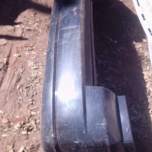 Used rear bumper for Dodge Caliber shown from rear angle, slight wear visible, ready for replacement.Used rear