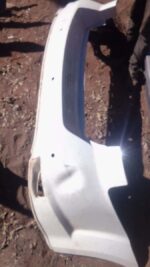 Used rear bumper for Nissan Sentra, viewed from the back, showing mounting points and surface details.Used rea
