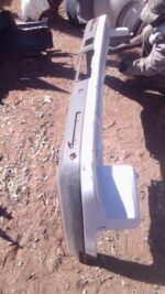 Rear view of a used Land Rover Discovery rear bumper showing mounting points and taillight cutouts.Rear view o