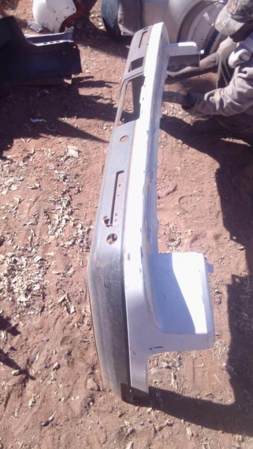 2005 Land Rover Discovery Rear Bumper - Used Rear view of a used Land Rover Discovery rear bumper showing mounting points and taillight cutouts.Rear view o