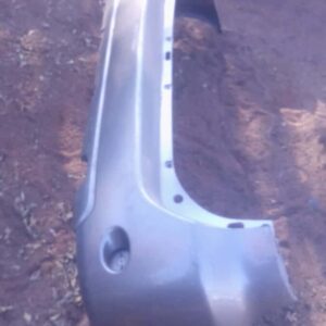 Rear view of a used Toyota Fortuner rear bumper, showing mounting points and reflector cutouts.Rear view of a