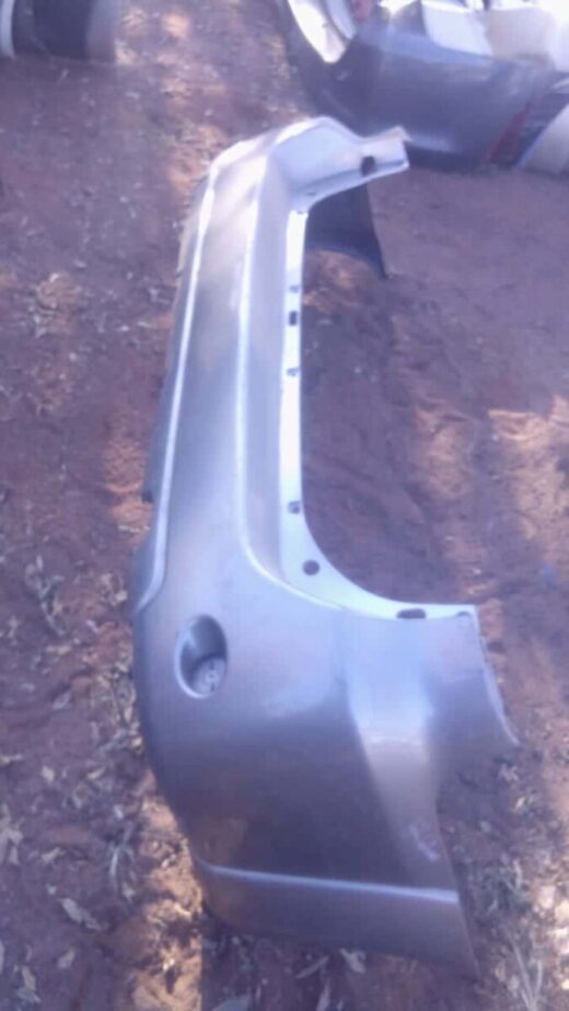 2010 Toyota Fortuner Rear Bumper - Used Rear view of a used Toyota Fortuner rear bumper, showing mounting points and reflector cutouts.Rear view of a