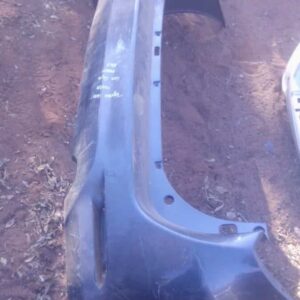 Rear bumper for Toyota Fortuner, viewed head-on, used condition, showing mounting points and overall shape.Rea