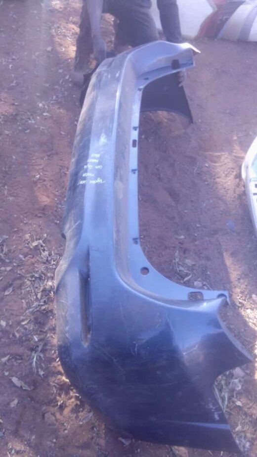 2014 Toyota Fortuner Rear Bumper - Used Rear bumper for Toyota Fortuner, viewed head-on, used condition, showing mounting points and overall shape.Rea