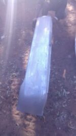 Rear bumper for 2005 Toyota Tazz shown from front angle, used condition with visible mounting points.Rear bump