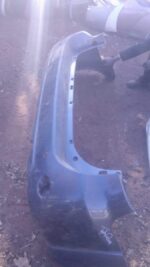 Used rear bumper for Toyota Fortuner shown from the back in a clean, plain background setting.Used rear bumper