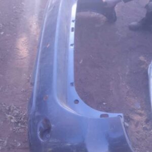 Used rear bumper for Toyota Fortuner shown from the back in a clean, plain background setting.Used rear bumper