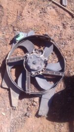 Front view of used radiator fan assembly for Nissan NP200 1.6 8v, showing blades and mounting points.Front vie