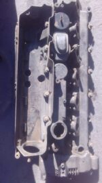 Used diesel engine tappet cover viewed from top with visible mounting points and surface details.Used diesel e