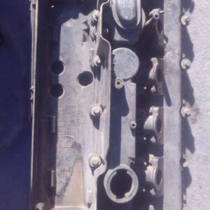 Used diesel engine tappet cover viewed from top with visible mounting points and surface details.Used diesel e