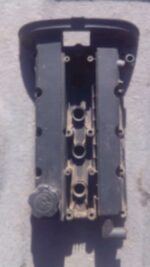Used tappet cover for 1.6 engine, shown angled front view with visible mounting holes.Used tappet cover for 1.