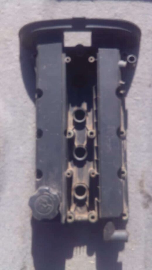2003 Daewoo Nibra 1.6 Tappet Cover - Used Used tappet cover for 1.6 engine, shown angled front view with visible mounting holes.Used tappet cover for 1.