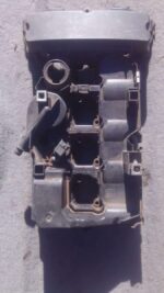 Top view of used Mercedes C180 engine tappet cover showing mounting holes and oil cap area.Top view of used Me