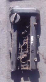 Top view of a used tappet cover with visible bolt holes and gasket surface for Hyundai I20.Top view of a used