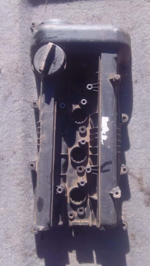 Hyundai I20 Tappet Cover - Used Top view of a used tappet cover with visible bolt holes and gasket surface for Hyundai I20.Top view of a used