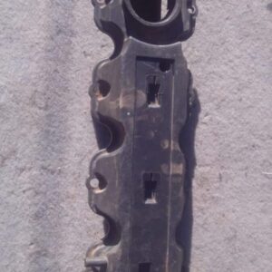 Used valve cover for Opel Corsa 1.6, shown from top angle highlighting bolt holes and gasket area.Used valve c