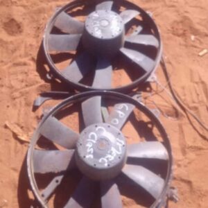 Front angled view of a used radiator fan assembly for Mercedes W202, showing blades and motor housing.Front an