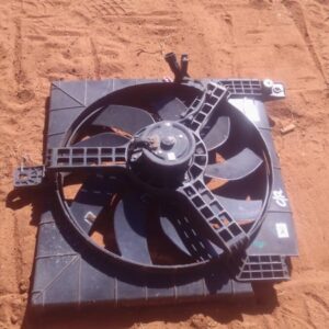 Front view of a used car radiator fan assembly with attached wiring harness, clean condition.Front view of a u