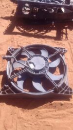 Front view of a used Hyundai Sonata radiator fan assembly with shroud and wiring harness visible.Front view of