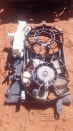Front view of a used radiator fan assembly for a 2008 Toyota Prius, showing blades and motor housing.Front vie