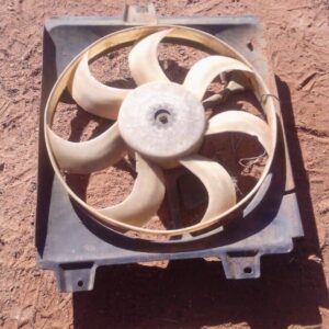 Front angle of used radiator fan assembly for 1.3 engine, showing blades and motor housing.Front angle of used