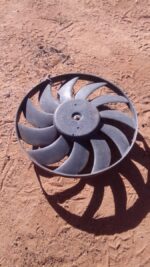 Front view of a used Ford KA radiator fan showing blades and motor assembly.Front view of a used Ford KA radia