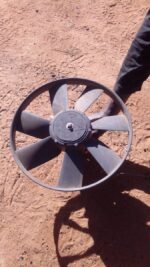 Front view of a used VW Caddy radiator fan with attached wiring and mounting points visible.Front view of a us