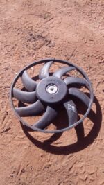 Front view of a used Audi A4 radiator fan assembly showing blades and housing on a white background.Front view