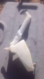 Front view of a used windshield washer bottle for a Volkswagen Polo Vivo.Front view of a used windshield washe