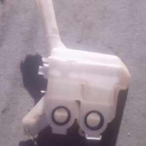 Used washer bottle for a 2009 Toyota Yaris, shown from the front with attached fluid cap and hose.Used washer
