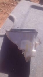Side view of a used E46 model water bottle with a black cap and clear body.Side view of a used E46 model water