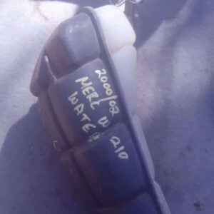 Side view of used Mercedes W210 water bottle with cap and mounting bracket visible against white background.Si