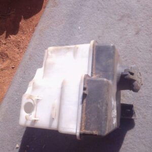 Front view of used Hyundai Getz washer bottle showing cap and spout, angled slightly to the left.Front view of