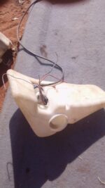 Used washer bottle viewed from the front showing mounting points and filler neck for Opel Monza.Used washer bo