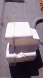 Used washer fluid bottle for Land Rover, shown front angle on plain background.Used washer fluid bottle for La