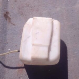 Front view of a used Volkswagen Golf 1 washer fluid bottle with attached cap and mounting points.Front view of