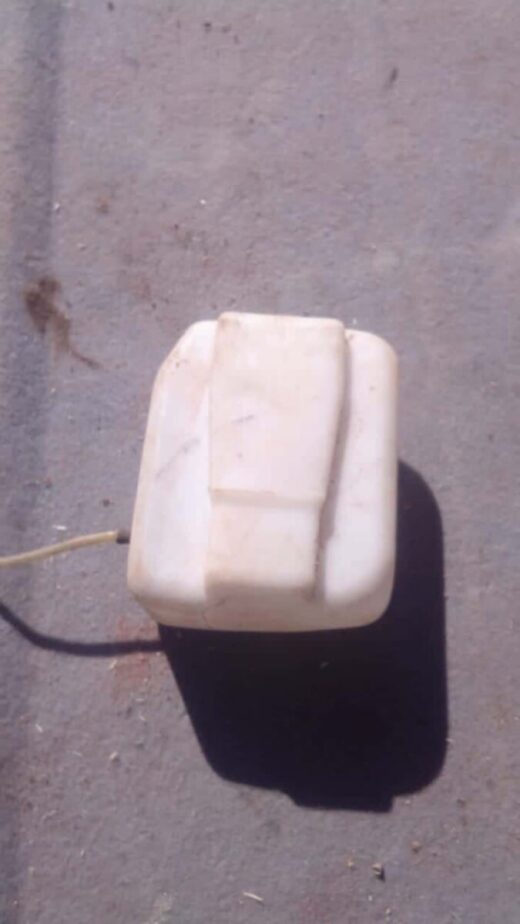Volkswagen Golf 1 Washer Bottle - Used Front view of a used Volkswagen Golf 1 washer fluid bottle with attached cap and mounting points.Front view of