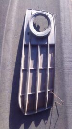 Right side spotlight cover for Audi A4 shown from the front angle, used condition visible.Right side spotlight
